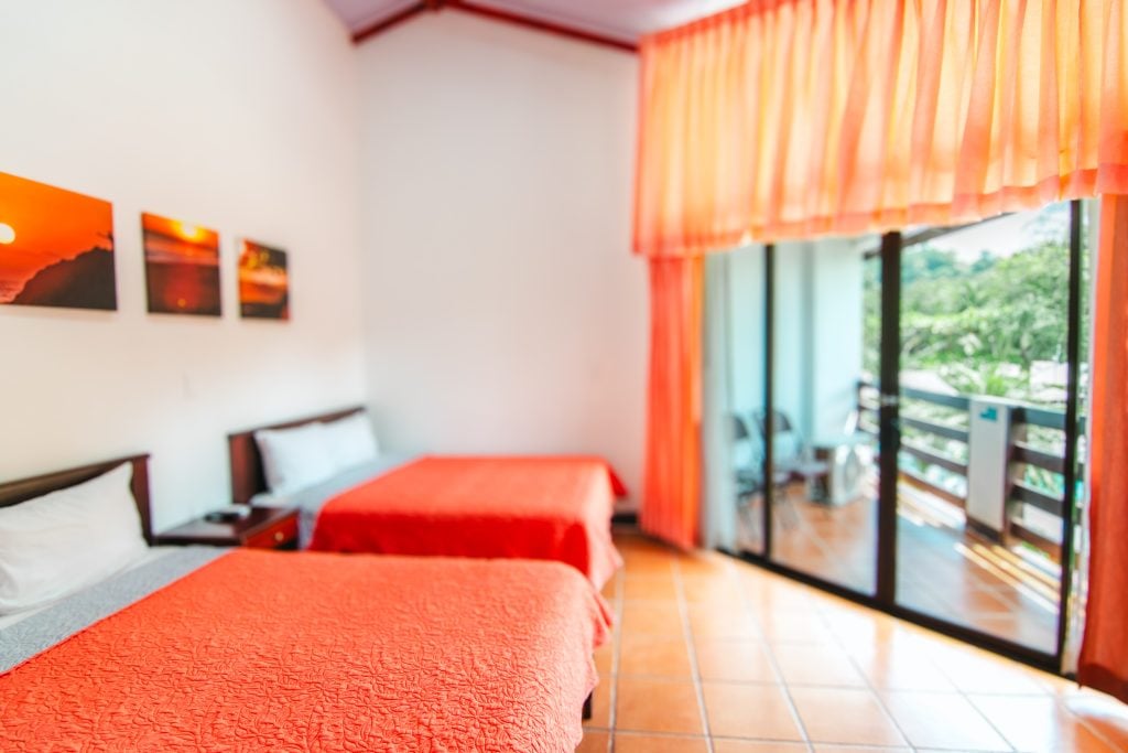Standard Room with two beds and a balcony onto the garden