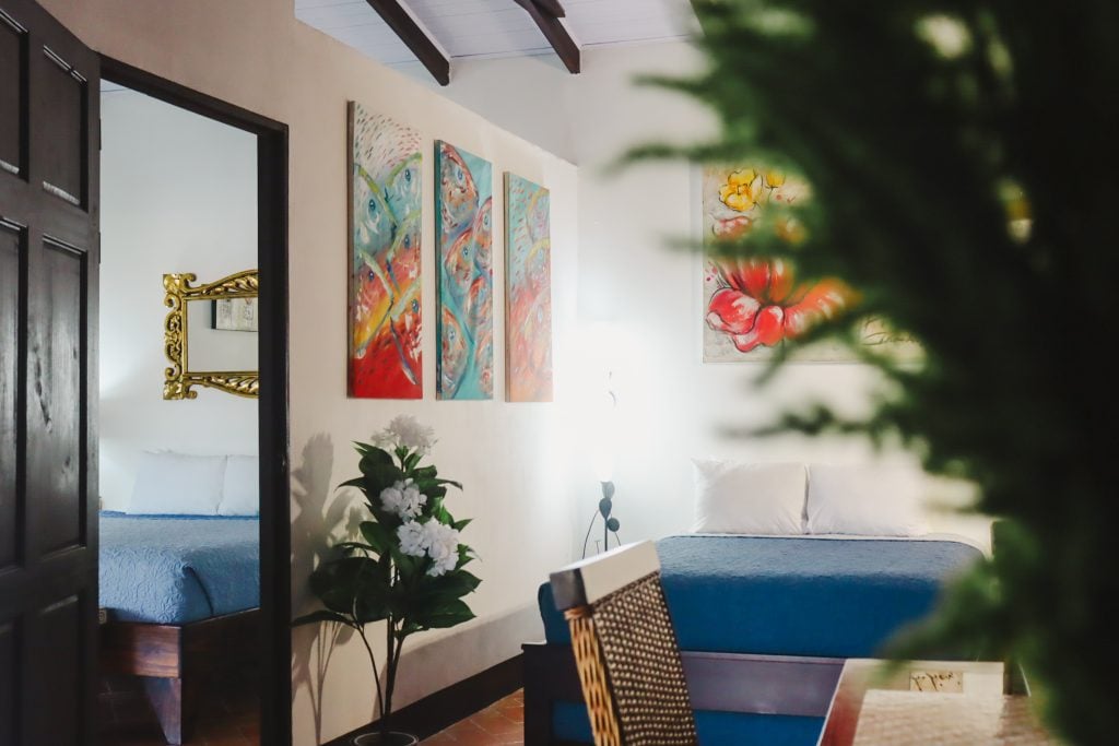 The villa living room with a blue sofa and fish artwork