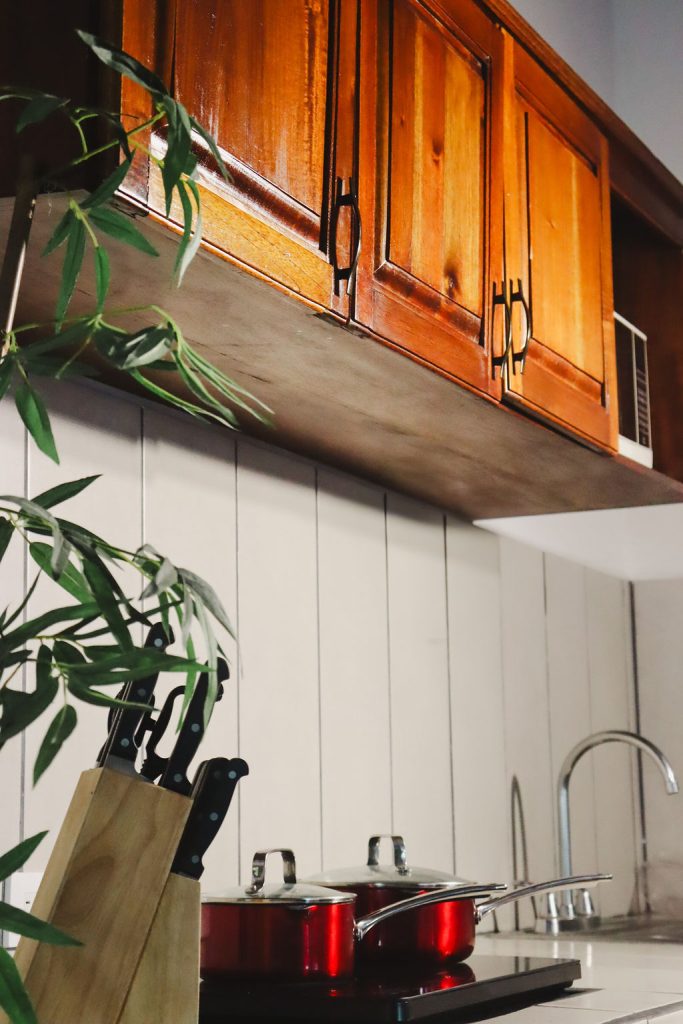 The villa kitchen with wooden cabinets and a sink